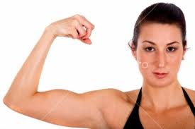 Woman showing off her bicep after a kettlebell workout